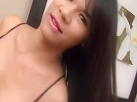 Busty Brunette Ladyboy In Black Dress Teases With Her Shaved Cock And Ass